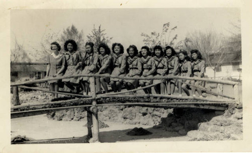 Poston Girl Scout troop on wooden walkway bridge