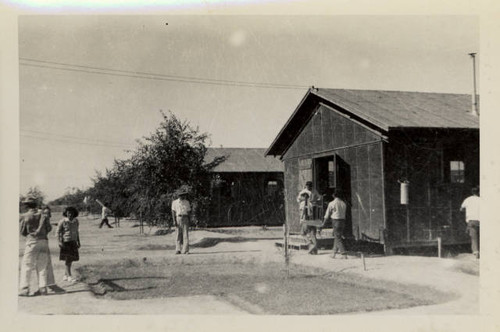 Students of Poston II Relocation Center school moving furniture to new school building