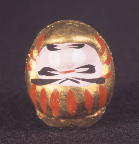 Daruma doll (painted red and gold)