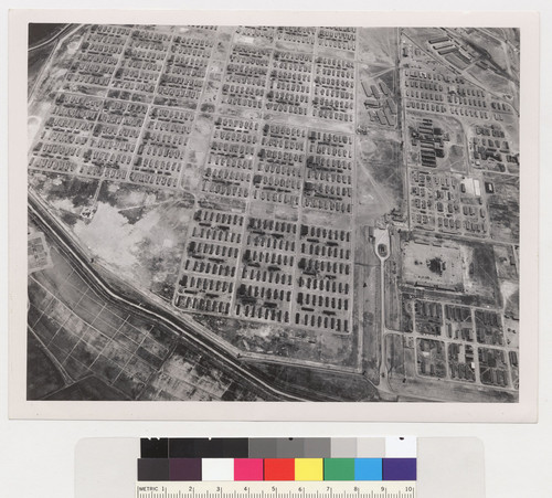 Tule Lake Center, 6 July 1945. Aerial view showing Military Police Area and main entrance (lower right), WRA Administration area (upper right) and evacuee living area (left center). High school can be seen in the fire break (upper right center)