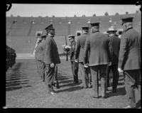 Chief Davis handles a firearm during the annual police inspection at Los Angeles Memorial Coliseum, Los Angeles, 1927