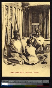 Women braiding a young girl's hair, Madagascar, ca.1900-1930