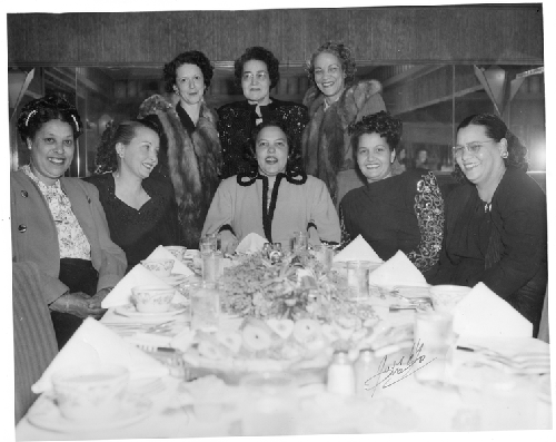 May Mooreland and Mrs. Elsie Jenkins (back row, center) posing with six unidentified women