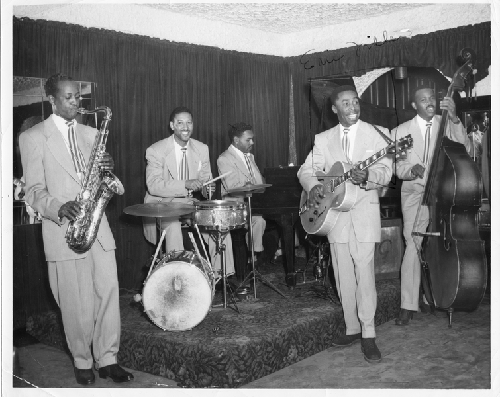 Musicians Jimmy Buchanan (sax), Earl Watkins (drums), Eric Miller (guitar), Commodore Lark (bass), Norvell Randall (piano) playing at Slim Jenkins Bar and Restaurant Oakland, California