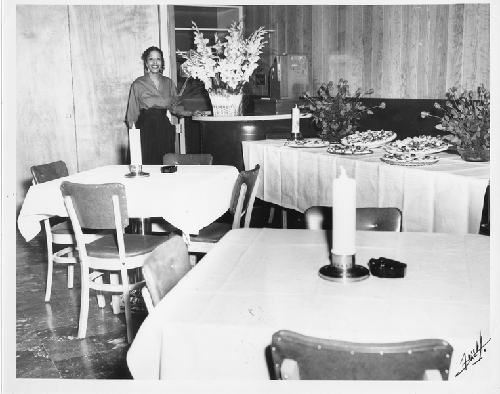 Waitress standing Slim Jenkins Bar and Restaurant dining room