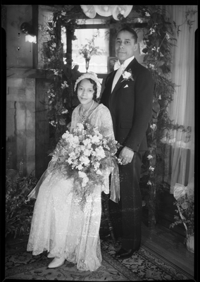 Wedding portrait of bride and groom in front of fireplace