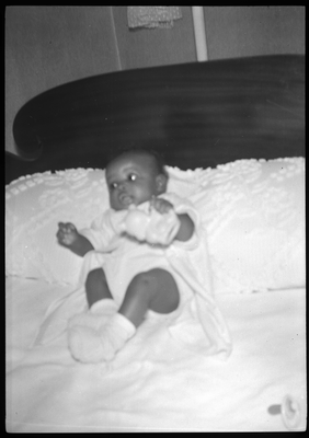 Baby lying on bed