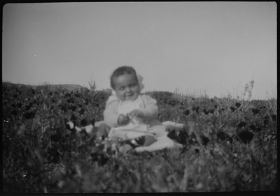 Baby sitting in field