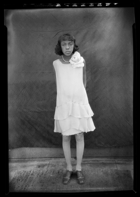 Portrait of a girl in sleeveless dress and corsage