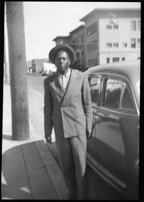 Man in suit standing on sidewalk