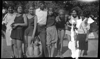 Group of men and women in swim suits at the beach