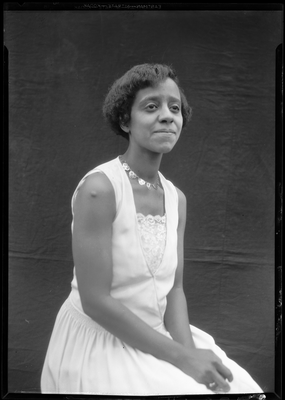 Portrait of a young woman in a sleeveless dress