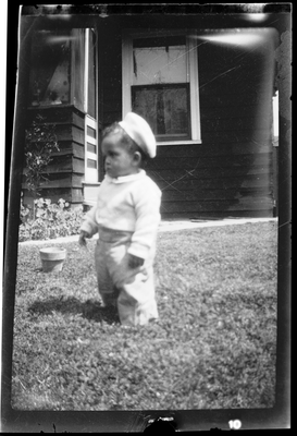 Baby standing in front yard