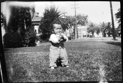 Baby standing in front yard