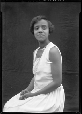 Portrait of a young woman in a sleeveless dress