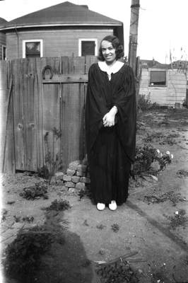 Muriel Taylor Collier in gown standing in backyard