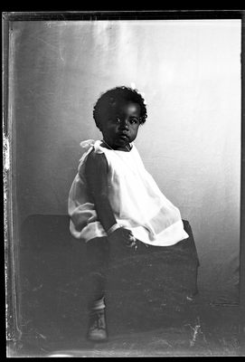 Portrait of girl with headband sitting on desk