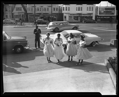 Bride and three bride's maids on sidewalk