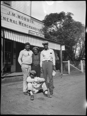 Four men in front of J.M. Morrin General Merchandise / Rumsey post office building