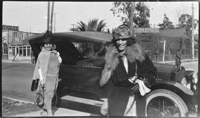 Pearl Hinds Roberts (left) and woman standing next to automobile