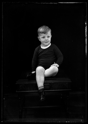 Portrait of a boy sitting on table