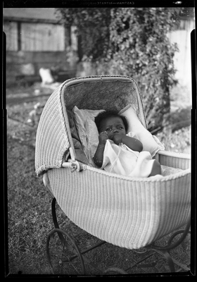 Baby in wicker carriage