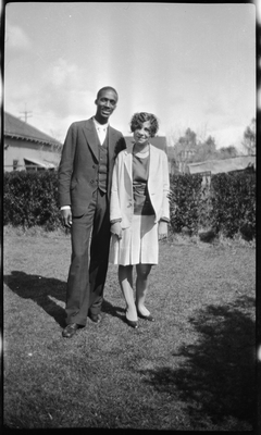 Man and woman standing in yard