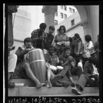 Group of "Venice bohemians" playing bongos on steps of Los Angeles City Hall to protest city ordinance, 1965