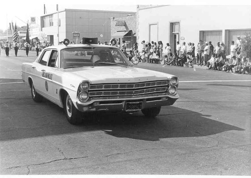 Delano's Harvest Holidays parade, with police car