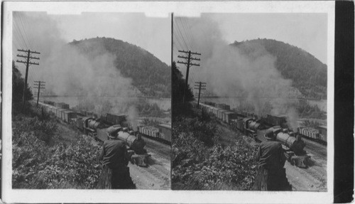 Two powerful engines pulling freight up 89 ft. grade around Horseshoe Curve. Penn