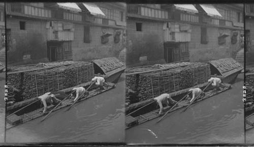 Native method of propelling canal boats on Escolta Canal, Manila, Philippine Islands