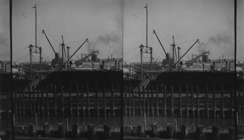 From upper decks of ferry looking to great ocean liners, Hoboken, N.J