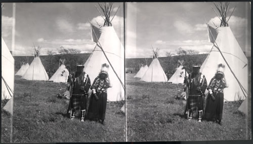 Indians (man & wife) in Camps. Glacier National Park, Montana