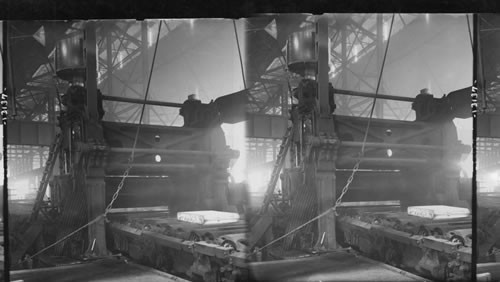 Flattened steel ingot going into rollers. Hot slab entering rolls to be rolled in 50-ft plate, rolling mill. Homestead, Penna