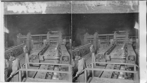 Billet "blooms" or rails being further compressed and lengthened in rolling mill. Homestead - Penna
