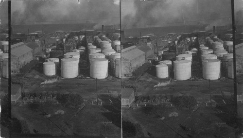 Looking east white tanks in foreground for lubricating stock - left in foreground, filters - back is compounding & canning plant. Back is paraffin wax bldg. In far background center round tanks are the lubricating oil agitators. Magnolia Petroleum Co., Beaumont, Texas