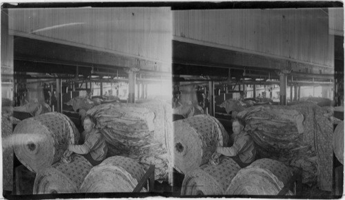 Lawrence, Mass. [Shows rolls of cotton cloth stacked.]