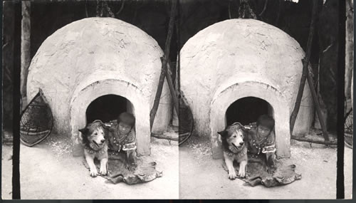 Igloo, dog, and boy in doorway. St. Louis World's Fair, Missouri