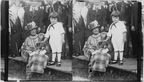 Mrs. Harding at Wrangell, Alaska, with small husky pup and George Elton Barnes 4 yrs. old of Wrangell