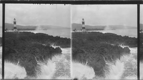 Waves dashing against the coral shore at lighthouse point. Near Port Antonio, Jamaica