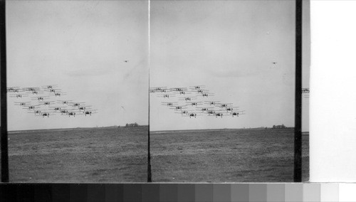 A large number of planes flying in formation during the air review passed by General Gilmore at Mather Field, Sacramento, Calif