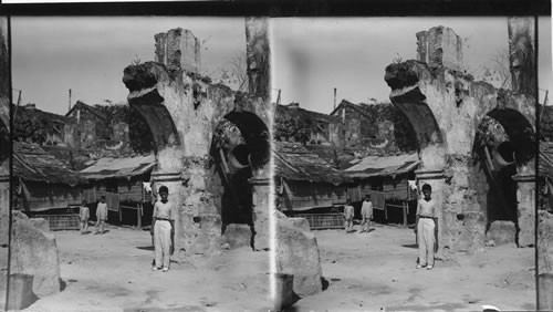 A Ruined Archway and Native Homes. Philippine Island