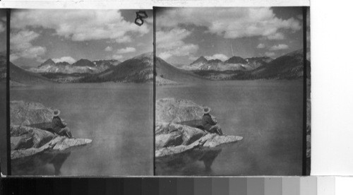 On the shore of Saddlebag Lake, N. N. W. to Sheep Peak at left, North Peak and Shepherd Crest, a Crest of red colored mountains. Calif. The colors in this scene were "most beautiful" The sky of a very deep blue incredibly so, while the water was very dark