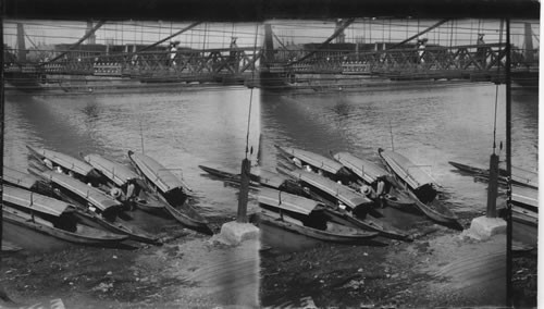 The ferry boats beneath the suspension bridge, Manila. Philippine Islands