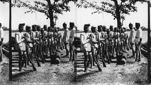 Moro guards with cast-iron gun manufactured by the Moros, Philippines