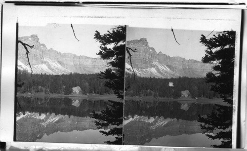 The castellated crest of the Ramshorn Mountains mirrored in the beautiful lake, Wyoming, [1901 Brooks Lake, Fremont Co. 1/18/38 Jean Murdock]