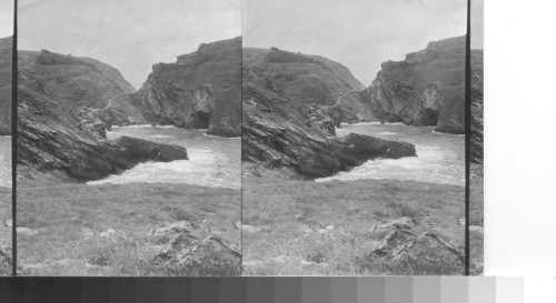 Tintagel head and Merlin's cave. The roadway leads to Tintagel castle, in legend, King Arthur's. Tintagel, Cornwall