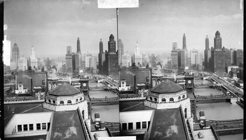 Opening of Lakes - to - Gulf Waterway. Pageantry and ceremony at Dedicatory program at Chicago River and Michigan Ave., Chicago, Ill., June 22nd, 1933. Chicago Skyline. From the merchandise mart, E. to Lake Michigan. Michigan Ave. Bridge is swinging open to allow passage of steamer. This is the last bridge on the Gulf -to- Lakes waterway and scene of the Dedication events