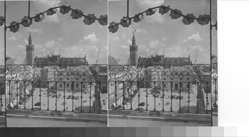 Right - Ayuntamiento facing Banco de Espana. Plaza de la constitution. The Giralda and the cathedral. Seville, Spain