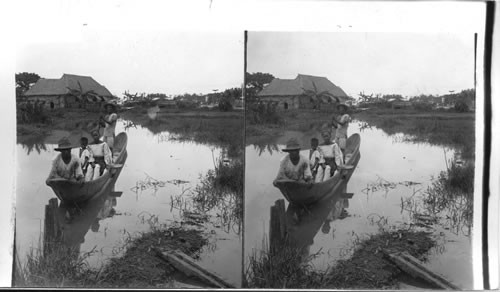 Native method of propelling canal boats on Escolta Canal, Manila. Philippine Islands